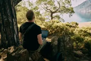 a man working laptop in nature